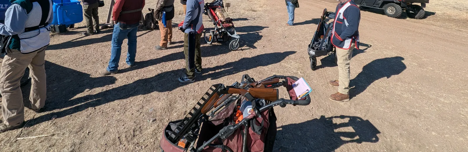 Sporting clays shooters waiting together at a station